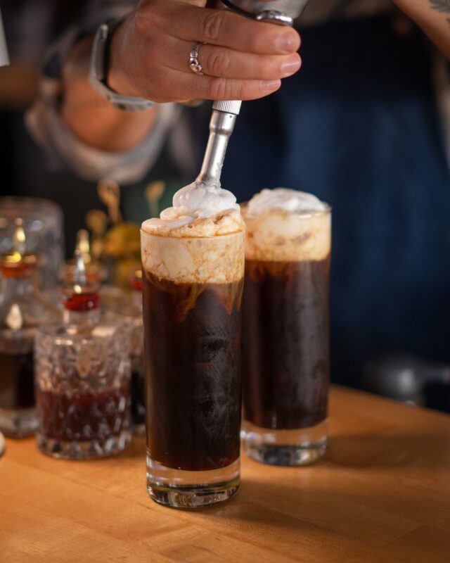 One of our favorite zero-proof creations. The Penguin Suit brings together iced coffee, chicory, and vanilla coconut cold foam for an afternoon boost that's anything but ordinary.